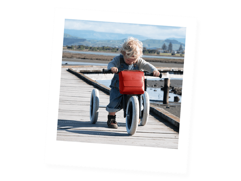 red leather bike bag on a child's trike